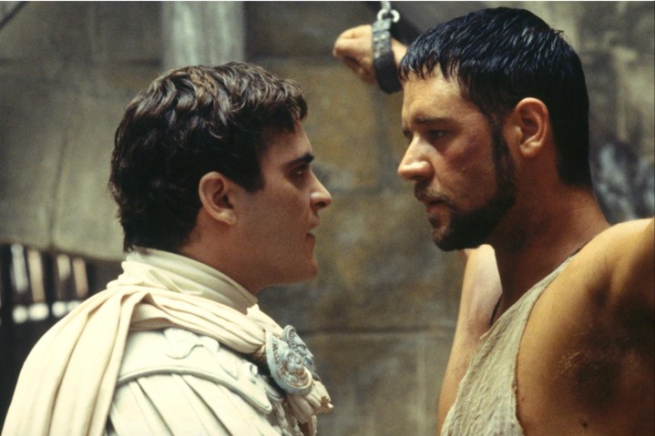 Joaquin Phoenix looks into the eyes of Russell Crowe, who is handcuffed.