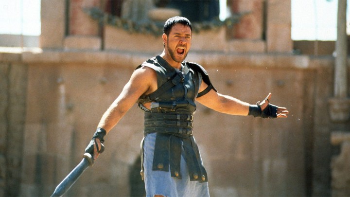 Russell Crowe stretches out his arms in the arena for Gladiator.